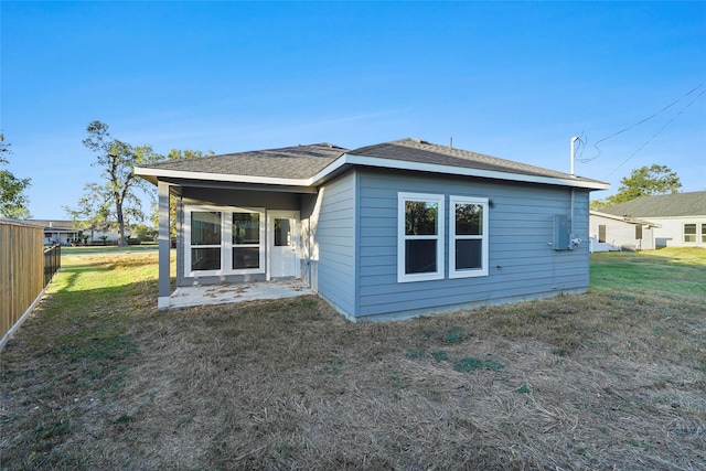 back of house with a yard