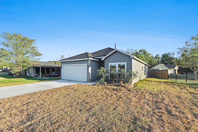 ranch-style house with a garage and a front lawn