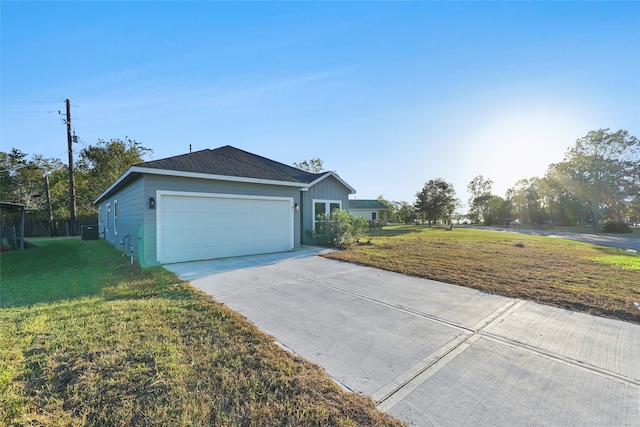 ranch-style house with a garage and a front lawn