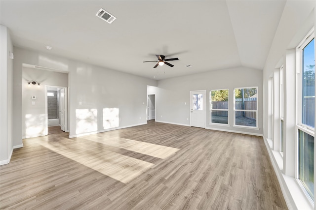 unfurnished room featuring light hardwood / wood-style floors, vaulted ceiling, and ceiling fan