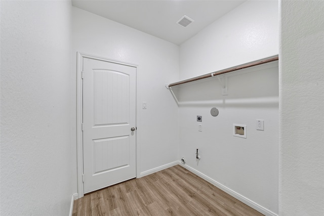 laundry room featuring gas dryer hookup, hookup for an electric dryer, hookup for a washing machine, and light wood-type flooring