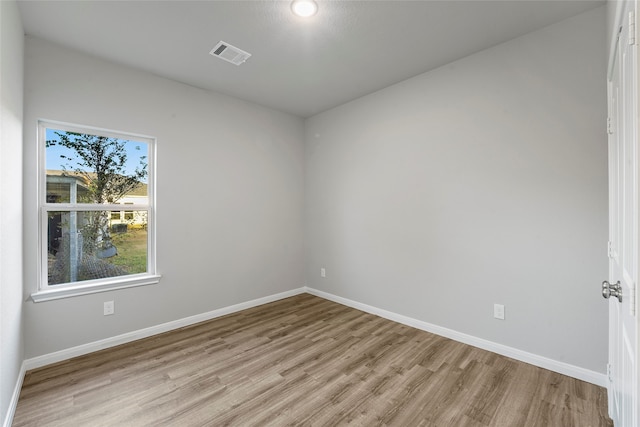 spare room featuring light hardwood / wood-style floors