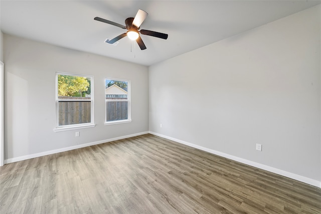 spare room featuring light hardwood / wood-style floors and ceiling fan