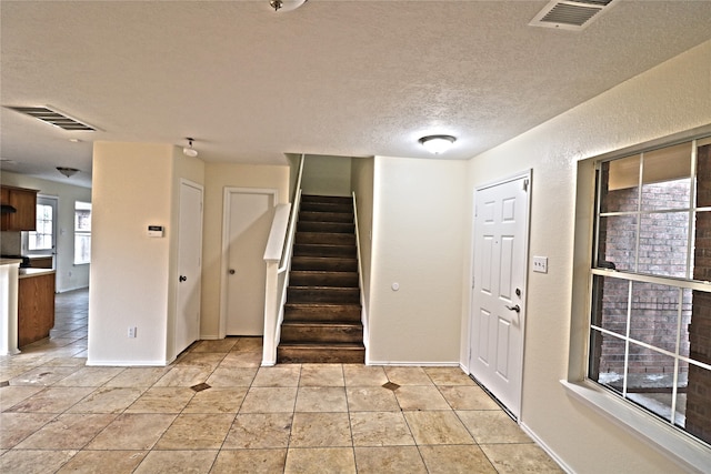 foyer with a textured ceiling