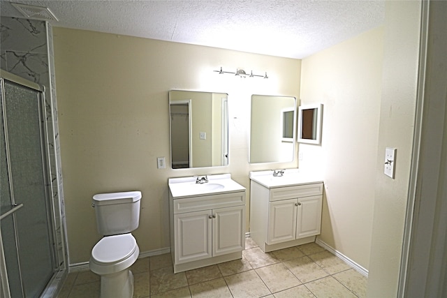 bathroom with a textured ceiling, an enclosed shower, toilet, tile patterned floors, and vanity