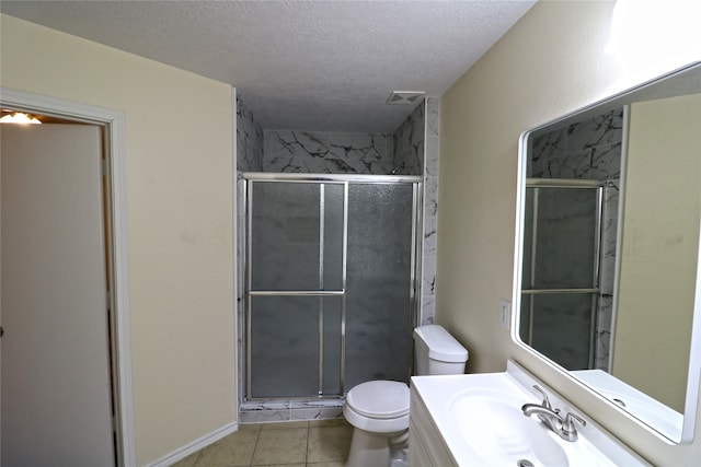 bathroom with tile patterned floors, a shower with shower door, and toilet