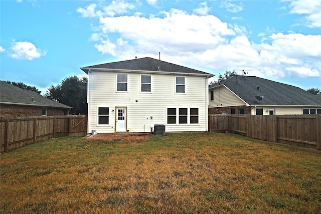 rear view of property featuring a patio, central AC, and a lawn