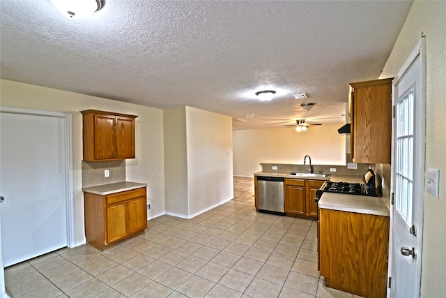 kitchen featuring kitchen peninsula, light tile patterned floors, a textured ceiling, stainless steel dishwasher, and sink