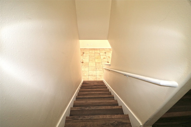 staircase featuring tile patterned floors