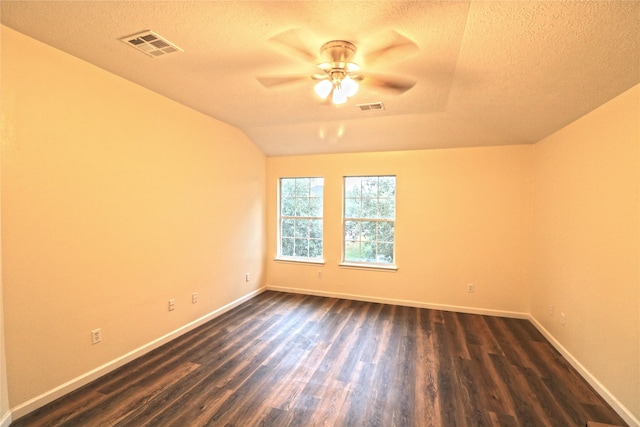 empty room featuring ceiling fan, a textured ceiling, and dark hardwood / wood-style flooring