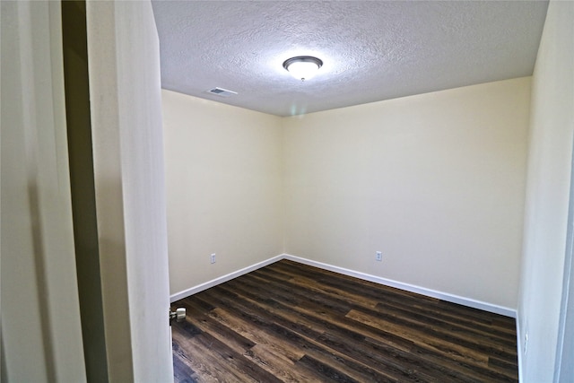 unfurnished room with a textured ceiling and dark wood-type flooring