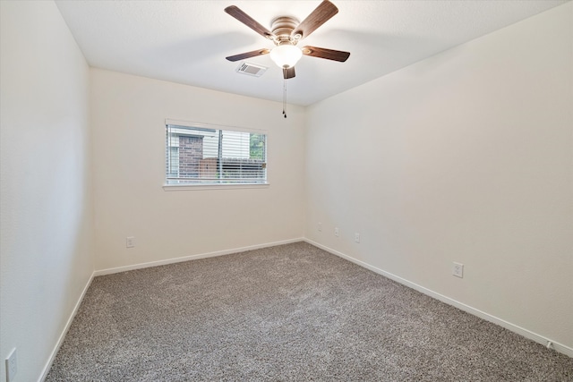 empty room featuring carpet flooring and ceiling fan