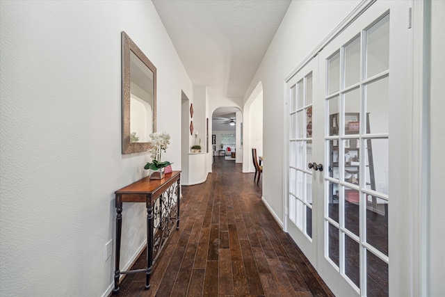 corridor with french doors and dark hardwood / wood-style floors