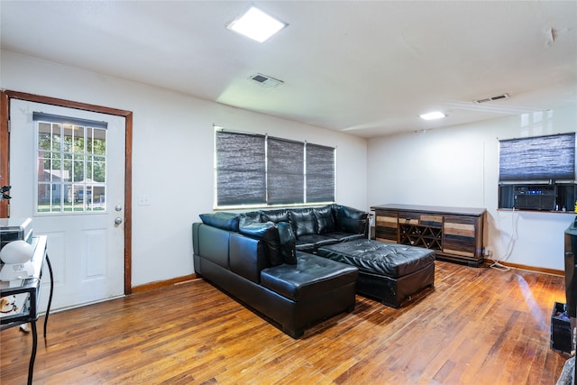 living room with hardwood / wood-style flooring and cooling unit