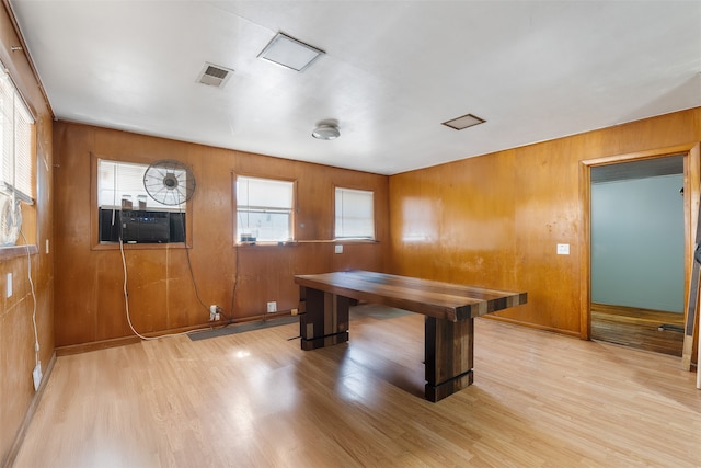 office area featuring wood walls, cooling unit, and light wood-type flooring