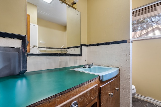 bathroom featuring vanity, toilet, and tile patterned floors