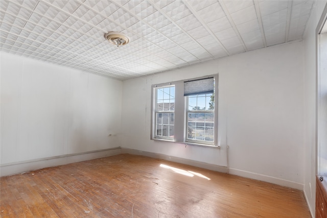 unfurnished room with hardwood / wood-style flooring