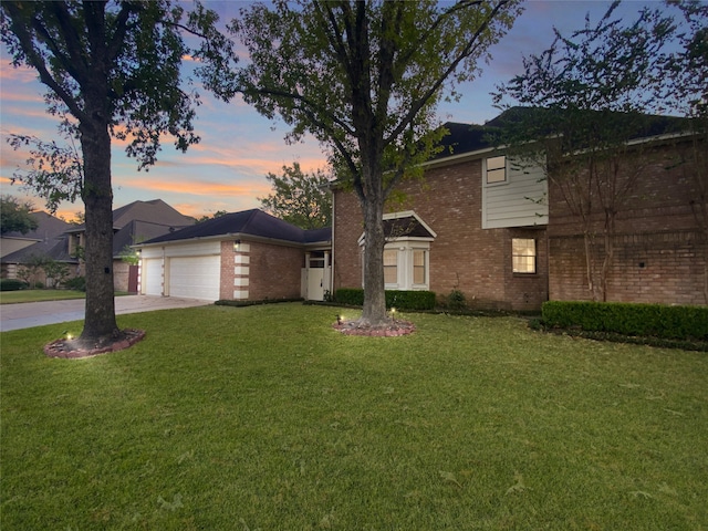 view of front property with a garage and a lawn