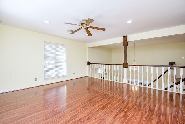 spare room featuring wood-type flooring and ceiling fan