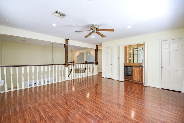 spare room featuring sink, hardwood / wood-style floors, and ceiling fan