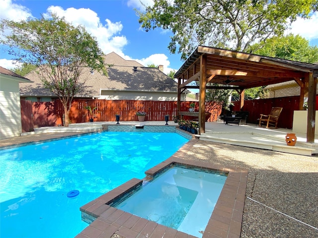 view of pool with an in ground hot tub, a gazebo, and a patio