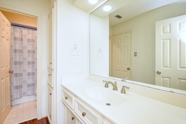 bathroom with vanity, curtained shower, and hardwood / wood-style flooring