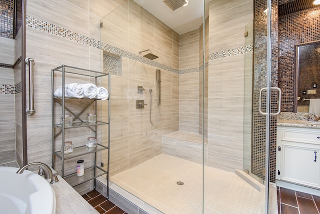 bathroom featuring vanity and separate shower and tub