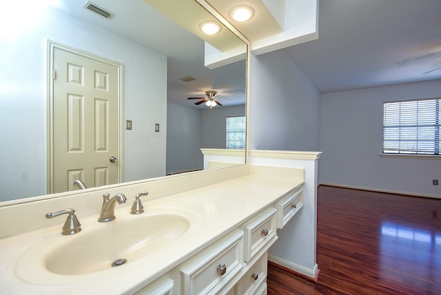 bathroom featuring a wealth of natural light, vanity, hardwood / wood-style floors, and ceiling fan