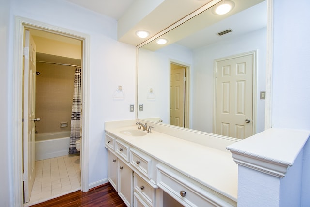 full bathroom featuring vanity, shower / bath combination with curtain, hardwood / wood-style flooring, and toilet