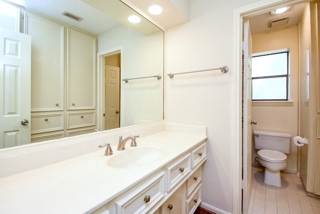 bathroom featuring vanity, toilet, and tile patterned floors