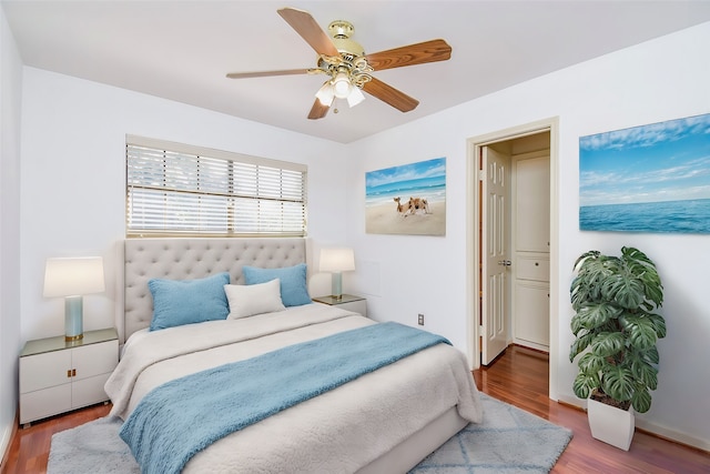 bedroom featuring connected bathroom, ceiling fan, and hardwood / wood-style flooring