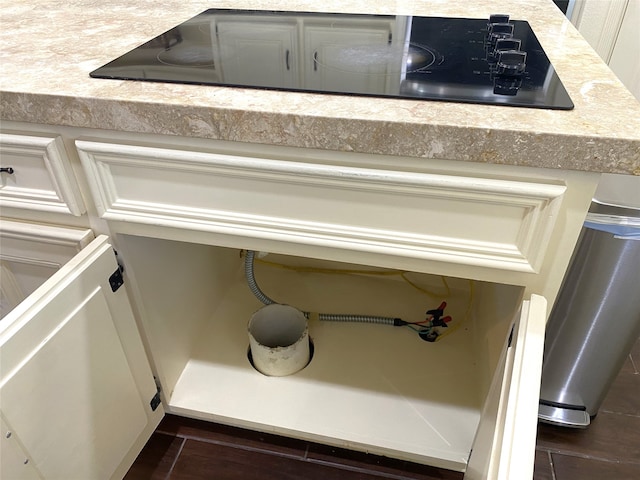 interior details with cream cabinets and black electric cooktop