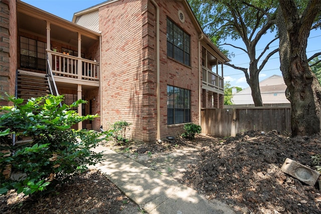 2255 Braeswood Park Dr Unit 184, Houston, TX 77030 - view of side of property with fence, stairs, and brick siding