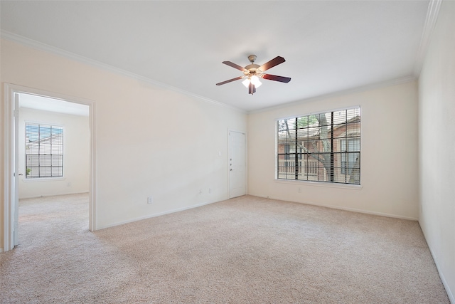 carpeted spare room featuring ornamental molding and ceiling fan