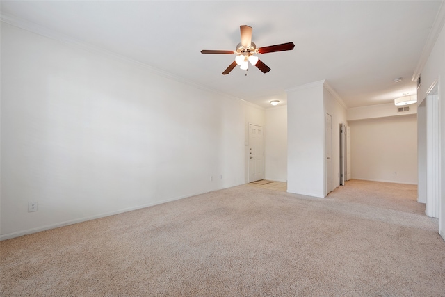 carpeted spare room featuring ornamental molding and ceiling fan