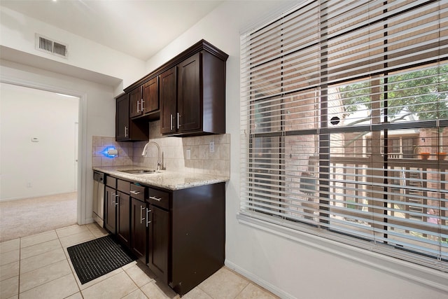 2255 Braeswood Park Dr Unit 184, Houston, TX 77030 - kitchen with a sink, visible vents, dark brown cabinets, light tile patterned flooring, and light stone countertops