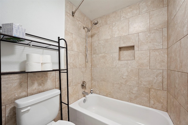 2255 Braeswood Park Dr Unit 184, Houston, TX 77030 - bathroom featuring washtub / shower combination, toilet, and tile walls