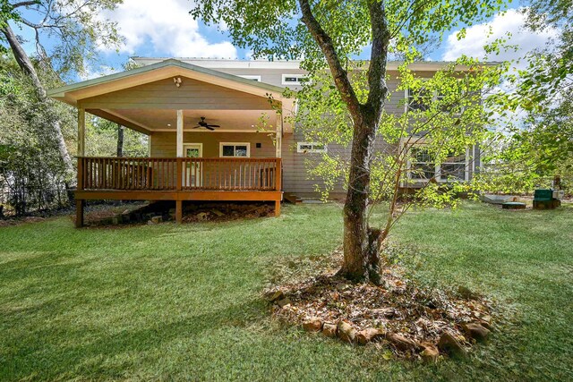 30626 Logger Ln, Magnolia, TX 77355 - rear view of house featuring a ceiling fan, a lawn, and a wooden deck