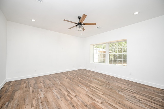 30626 Logger Ln, Magnolia, TX 77355 - empty room featuring wood finished floors, ceiling fan, baseboards, and recessed lighting