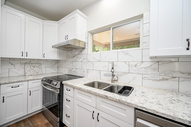 30626 Logger Ln, Magnolia, TX 77355 - kitchen with under cabinet range hood, stainless steel range with electric cooktop, a sink, dishwasher, and white cabinets