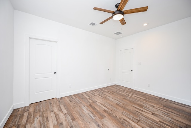 unfurnished room with ceiling fan and wood-type flooring