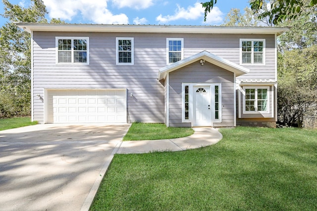 view of front of property featuring a front yard and a garage