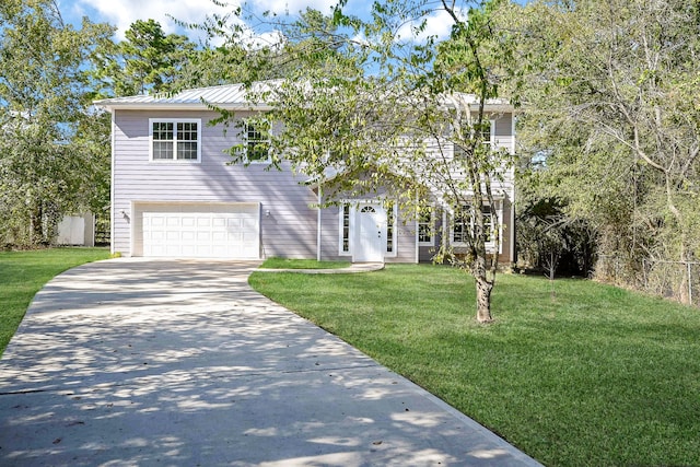 view of front of house featuring a front yard and a garage