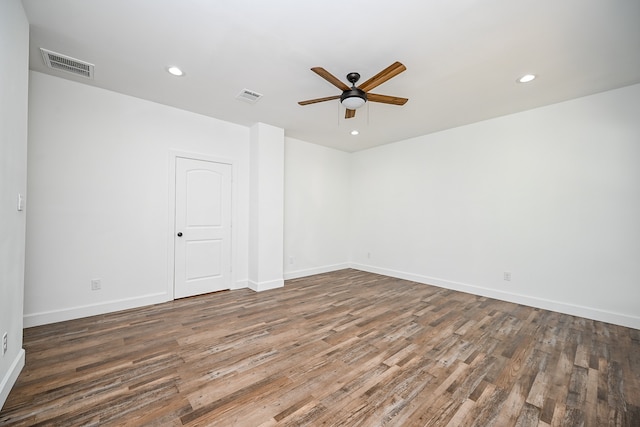 empty room featuring ceiling fan and dark hardwood / wood-style floors