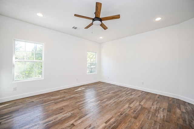 unfurnished room featuring ceiling fan and dark hardwood / wood-style flooring