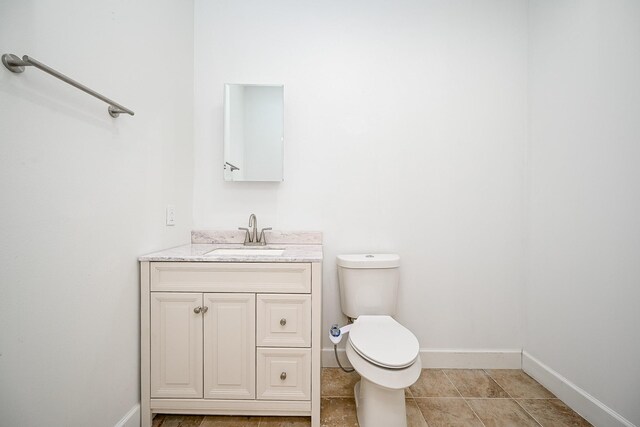 30626 Logger Ln, Magnolia, TX 77355 - bathroom with baseboards, toilet, and vanity