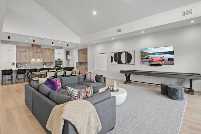 living room featuring wood ceiling, high vaulted ceiling, and light wood-type flooring