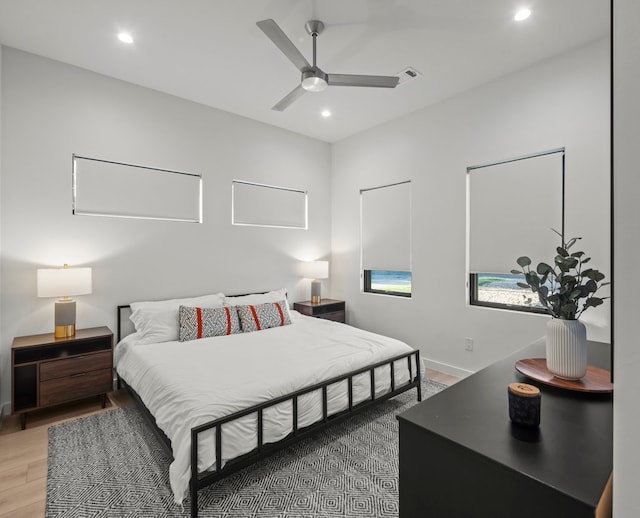 bedroom with hardwood / wood-style floors and ceiling fan