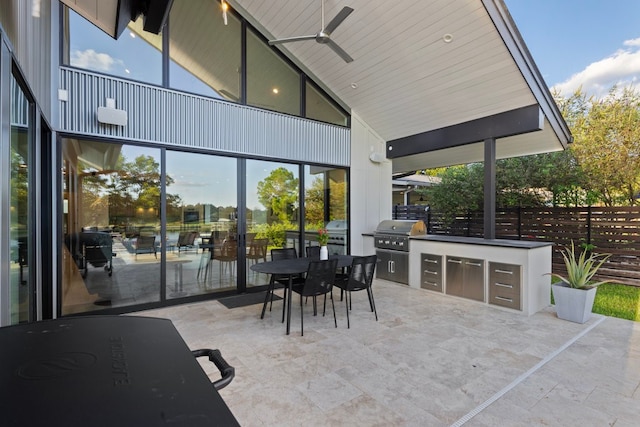 view of patio featuring an outdoor kitchen and a grill