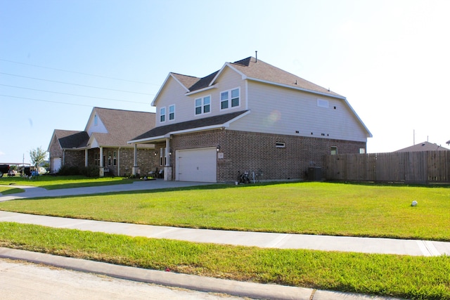 view of side of home with a yard, a garage, and central AC unit